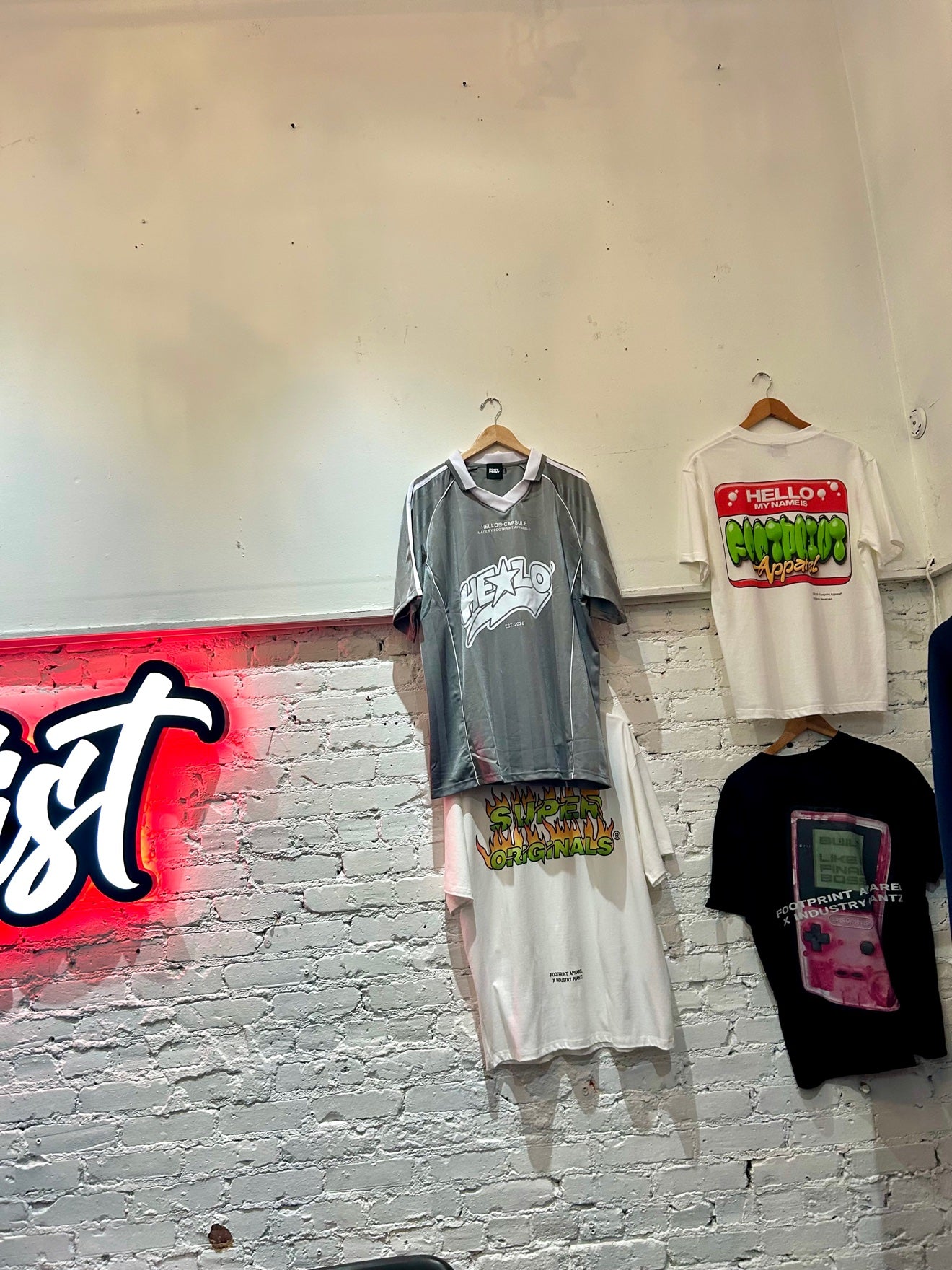 Footprint Apparel graphic tees hanging on the store wall