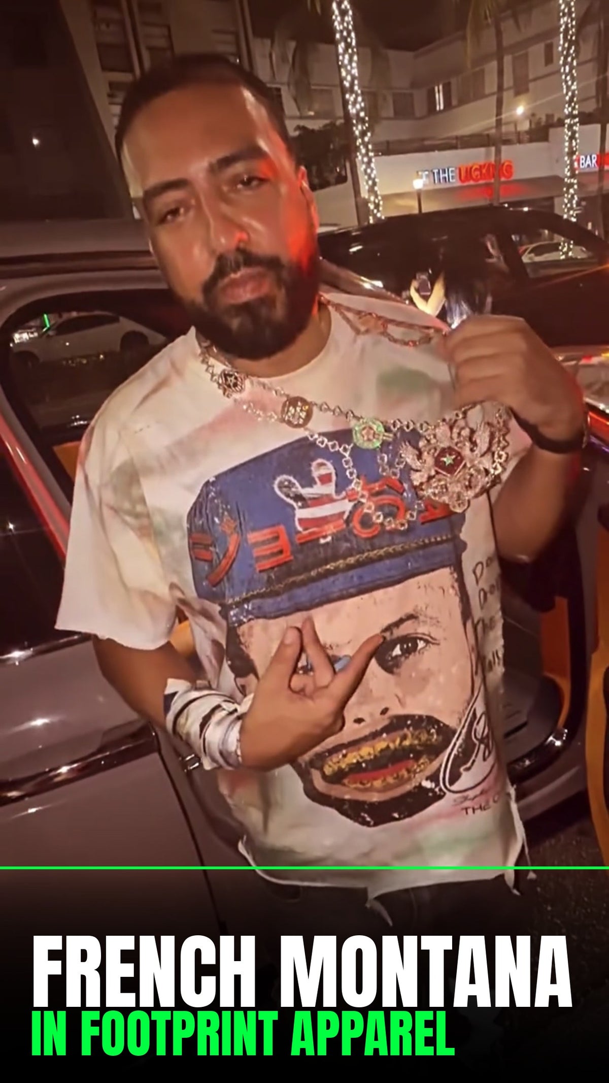 French Montana wearing a Footprint Apparel Golden Grit tee at night
