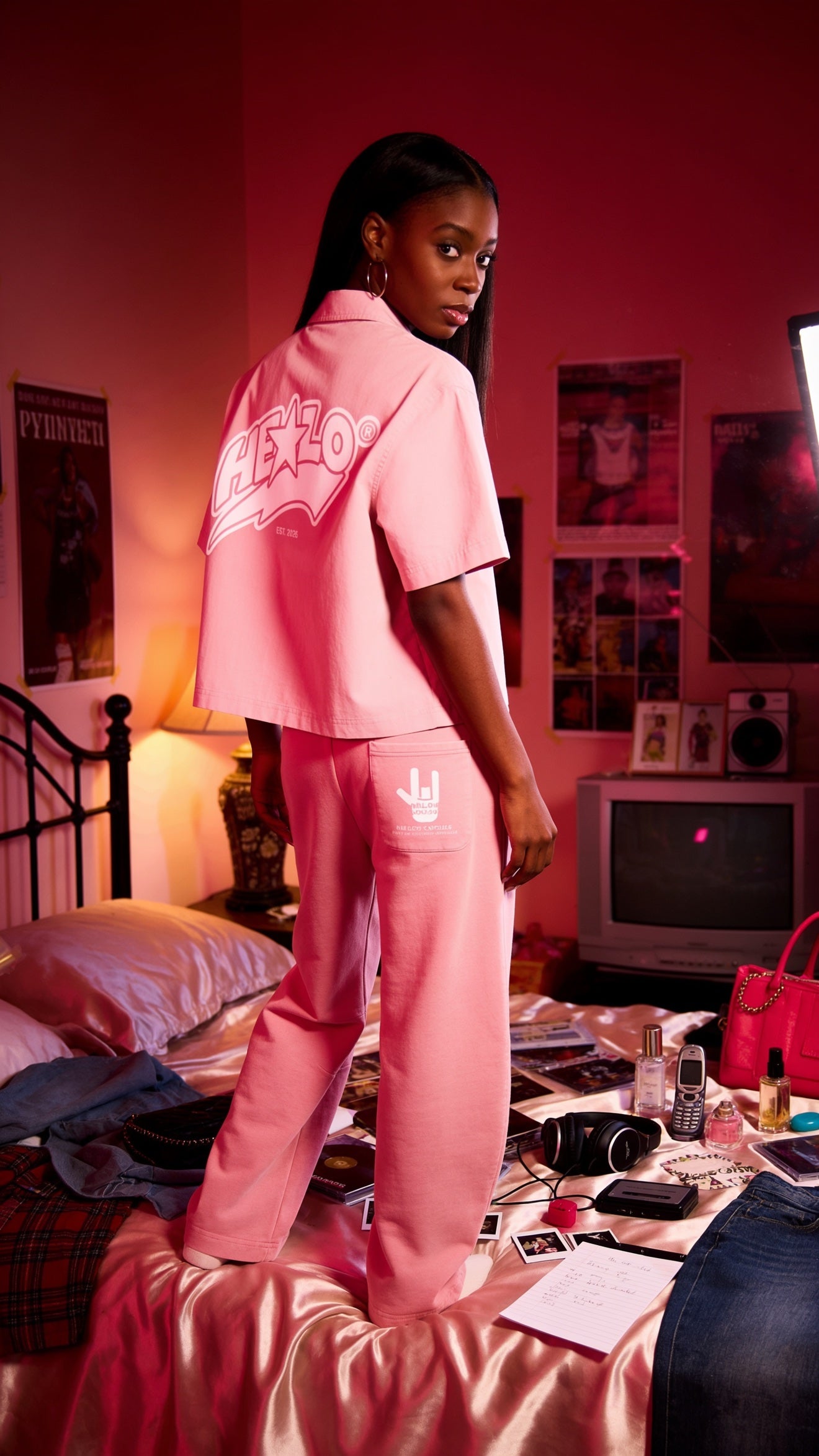 Footprint Apparel women's streetwear — woman with her back to the camera in a pink HE★LO button-up shirt