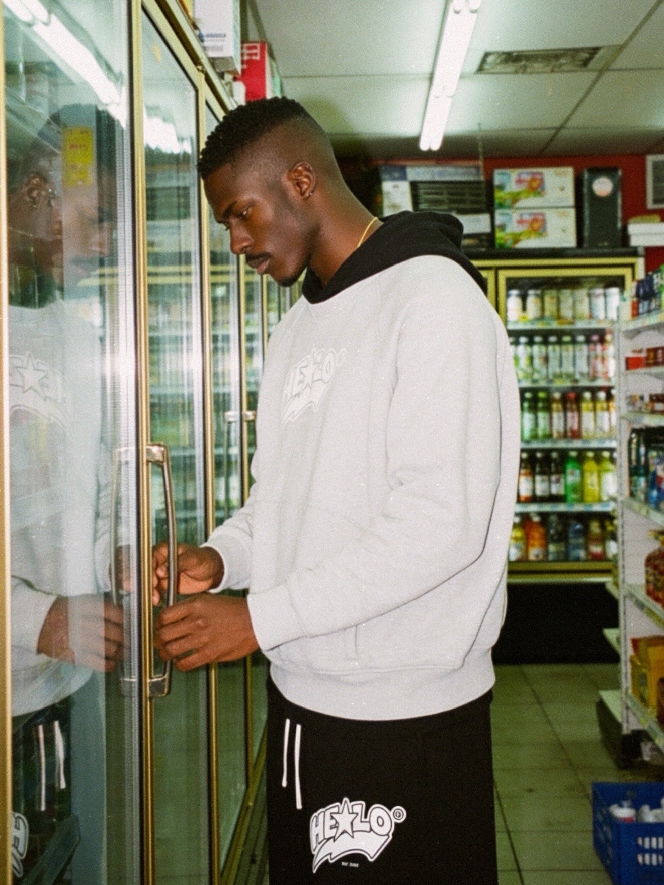 Grey HELLO hoodie look at a corner store