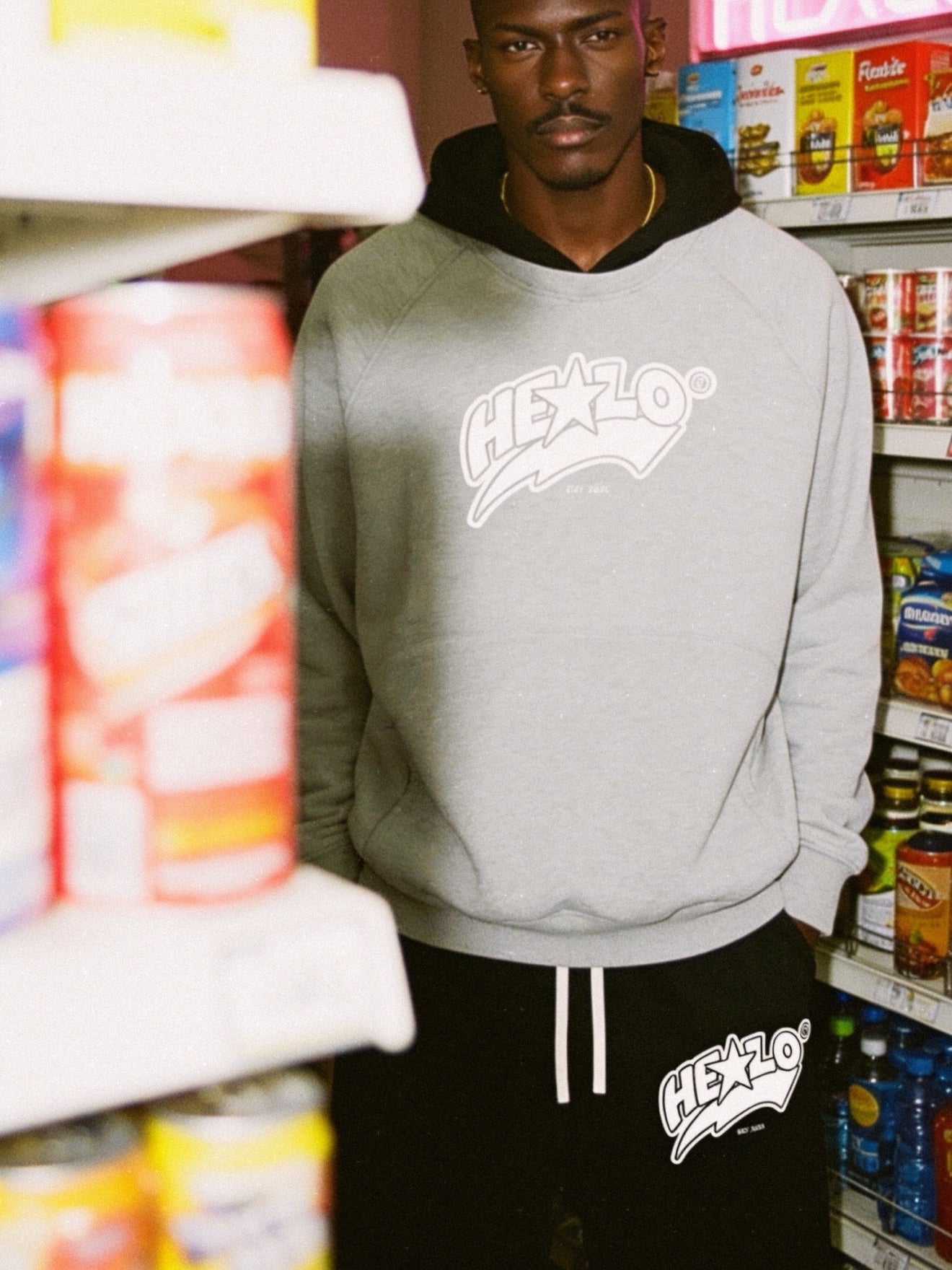 Grey HELLO hoodie in a store aisle